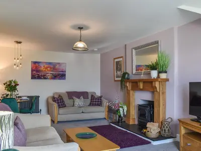 a living room with a couch and a fireplace at Ted's Place in Arnside