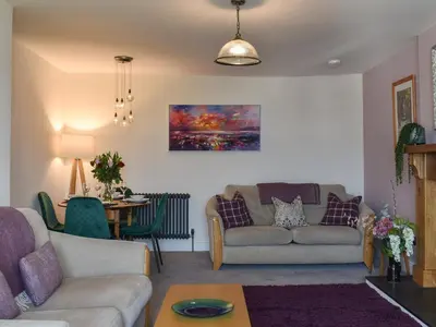 a living room with a couch and a table at Ted's Place in Arnside