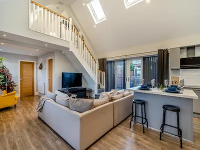 a living room with a couch and a kitchen at Ferndale Bungalow in Hambleton