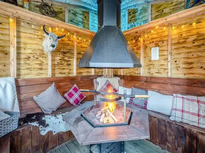 a fireplace in a cabin with a goat on the wall at Ferndale Bungalow in Hambleton