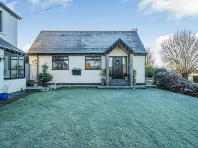 a house with a large yard in front of it at Ferndale Bungalow in Hambleton
