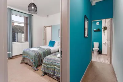 a blue room with a bed and a toilet at Hornsey House - Air Host & Stay - 5 Bedrooms Sleeps 10 in Liverpool