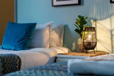 a bedroom with two beds and a lamp on a table at Hornsey House - Air Host & Stay - 5 Bedrooms Sleeps 10 in Liverpool