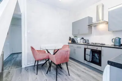 a kitchen with a table and two chairs at Trendy house, close to stadiums, free wifi and car park in Liverpool