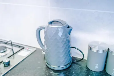 a blue vase sitting on a counter next to a stove at Trendy house, close to stadiums, free wifi and car park in Liverpool