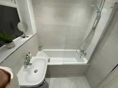 a white bathroom with a shower and a sink at Wharfedale Lodge- Bungalow-3 Bed, 2 bath, Amazing! in Thornton