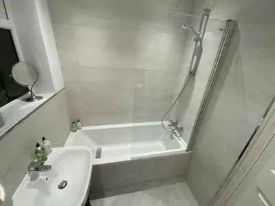 a white bathroom with a shower and a sink at Wharfedale Lodge- Bungalow-3 Bed, 2 bath, Amazing! in Thornton
