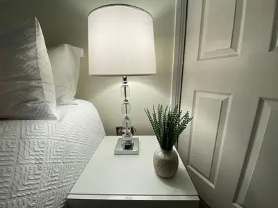 a lamp on a table next to a bed at Wharfedale Lodge- Bungalow-3 Bed, 2 bath, Amazing! in Thornton