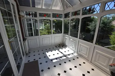 an empty room with a bunch of windows at The Nutshell in Southport