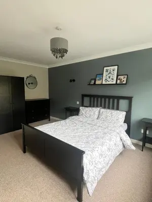 a bedroom with a large bed with a white comforter at The Nutshell in Southport