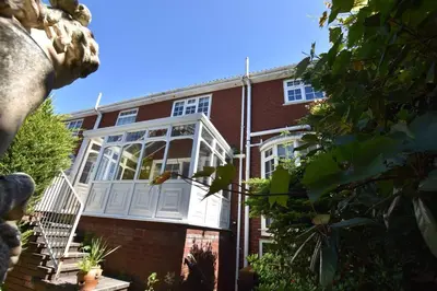a red brick building with a white porch on it at The Nutshell in Southport