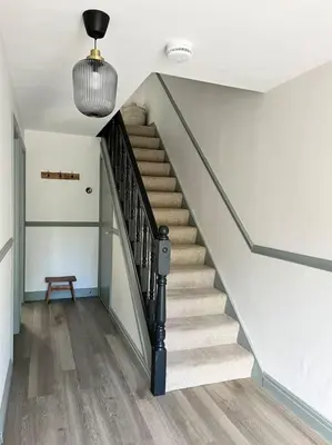 a staircase in a house with a pendant light at The Cottage, a perfect getaway! in Southport