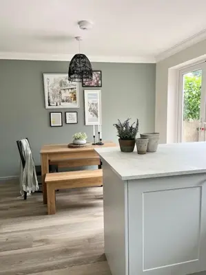 a kitchen with a white counter and a table at The Cottage, a perfect getaway! in Southport