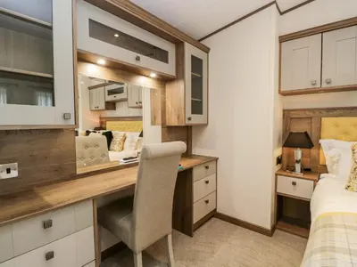 a bedroom with a desk and a bed in a room at Hudson's Hideaway in Carnforth