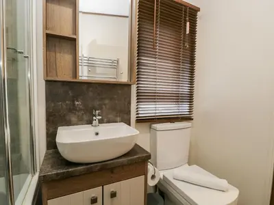 a bathroom with a sink and a toilet at Hudson's Hideaway in Carnforth