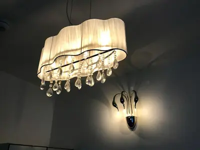 a white chandelier hanging from a ceiling at 77 Park Road Apartments in Blackpool