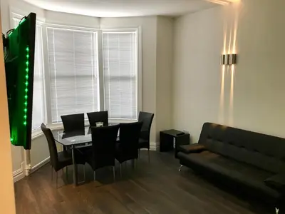 a dining room with a table and chairs and a couch at 77 Park Road Apartments in Blackpool