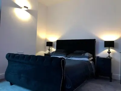 a bedroom with a bed and a couch at 77 Park Road Apartments in Blackpool