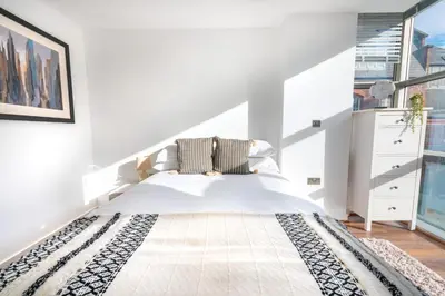 a white bedroom with a large bed and large windows at Free Parking Modern Balcony 2 Bed City Centre in Liverpool