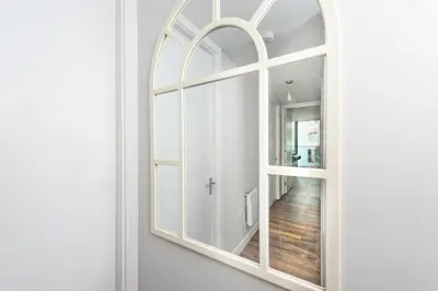 a large mirror on a wall in a room at Free Parking Modern Balcony 2 Bed City Centre in Liverpool