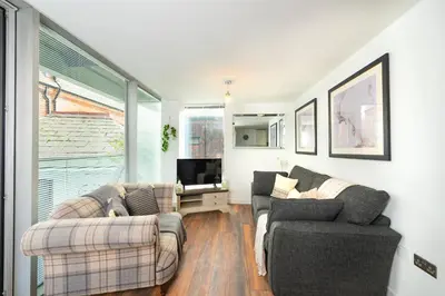 a living room with two couches and a tv at Free Parking Modern Balcony 2 Bed City Centre in Liverpool