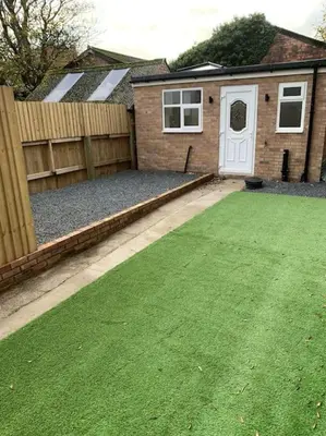 a backyard with a fence and a white door at Town Centre Getaway in Southport