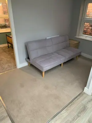 a gray couch sitting in a living room at Town Centre Getaway in Southport