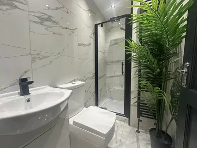a bathroom with a sink and a shower and a toilet at 4 Bedroom Anfield House, 7 beds, Free Parking, Garden - 5 mins to LFC, 15 mins to City Centre in Liverpool