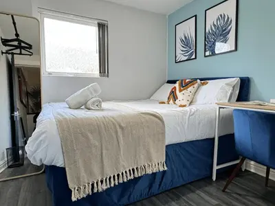 a bedroom with a bed and a window at 4 Bedroom Anfield House, 7 beds, Free Parking, Garden - 5 mins to LFC, 15 mins to City Centre in Liverpool