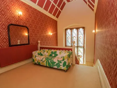 a living room with a couch and a mirror at Millwood Manor in Barrow in Furness