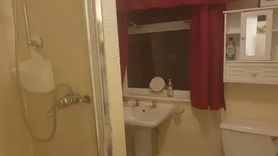a bathroom with a sink and a toilet and a mirror at The Brema Hotel in Blackpool