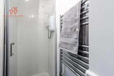 a bathroom with a shower and a towel rack at Stylish 3-Bed Sleeps 8 Liverpool free wifi carpark By Hinkley Homes Short Lets & Serviced Accommodation in Liverpool