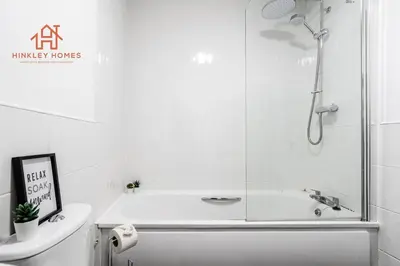 a white bathroom with a shower and a bath tub at Stylish 3-Bed Sleeps 8 Liverpool free wifi carpark By Hinkley Homes Short Lets & Serviced Accommodation in Liverpool
