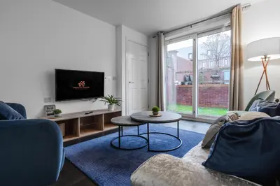 a living room with a couch and a tv and a table at Stylish 3-Bed Sleeps 8 Liverpool free wifi carpark By Hinkley Homes Short Lets & Serviced Accommodation in Liverpool