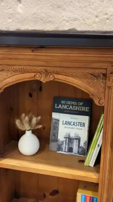 a book shelf with a vase and a book at 3 Bed City Home - South Facing Patio - 4-5 Beds in Lancaster