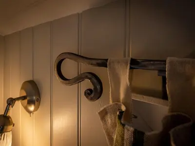 a towel holder on a wall next to a lamp at The Pleasant Hut at Mount Pleasant Farm in Ulverston