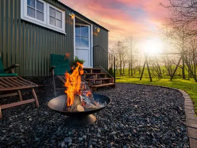 a fire pit in front of a house at The Pleasant Hut at Mount Pleasant Farm in Ulverston