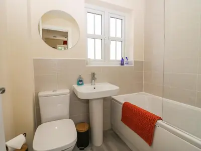 a bathroom with a toilet and a sink and a bath tub at Rolo's Retreat in Grange Over Sands