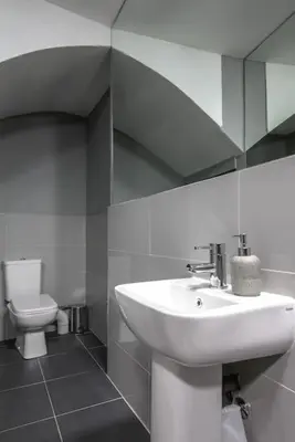 a bathroom with a sink and a toilet at The V.I.P Suite - Sleeps 24! Best for large groups in Liverpool