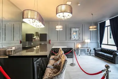 a living room with a bar with a red hose at The V.I.P Suite - Sleeps 24! Best for large groups in Liverpool