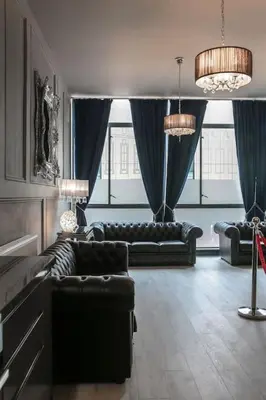 a living room with two leather couches and windows at The V.I.P Suite - Sleeps 24! Best for large groups in Liverpool