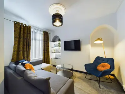 a living room with a couch and a table at Charming Apartments - Cosy Retreat - short drive to city centre - Free parking in Liverpool