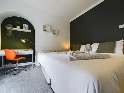 a bedroom with a bed and a desk and a chair at Charming Apartments - Cosy Retreat - short drive to city centre - Free parking in Liverpool