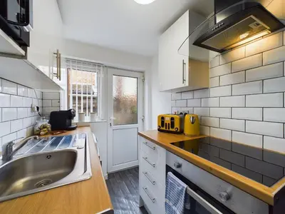 a kitchen with a sink and a counter top at Charming Apartments - Cosy Retreat - short drive to city centre - Free parking in Liverpool