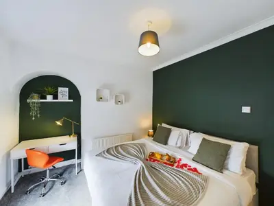 a bedroom with a bed with a desk and a chair at Charming Apartments - Cosy Retreat - short drive to city centre - Free parking in Liverpool