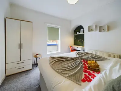 a white bedroom with a bed and a dresser at Charming Apartments - Cosy Retreat - short drive to city centre - Free parking in Liverpool