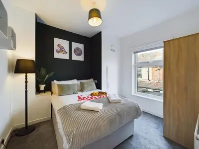 a bedroom with a bed and a window at Charming Apartments - Cosy Retreat - short drive to city centre - Free parking in Liverpool