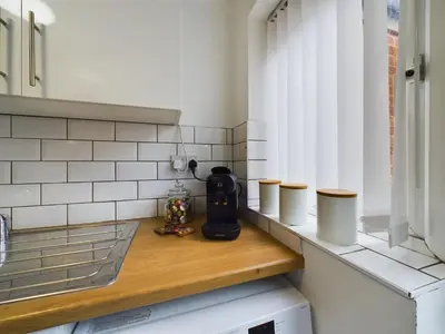 a counter in a kitchen with cups on it at Charming Apartments - Cosy Retreat - short drive to city centre - Free parking in Liverpool