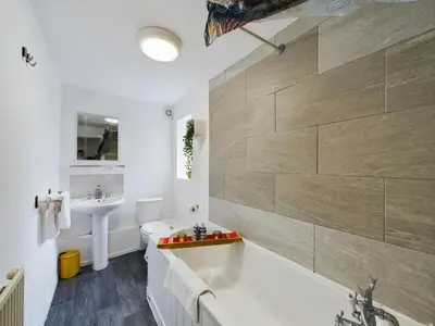 a bathroom with a tub and a sink at Charming Apartments - Cosy Retreat - short drive to city centre - Free parking in Liverpool