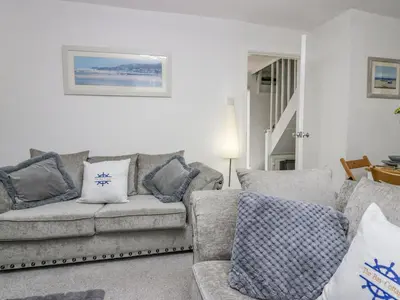a living room with a couch and pillows at The Bay Cottage - Morecambe Bay in Morecambe